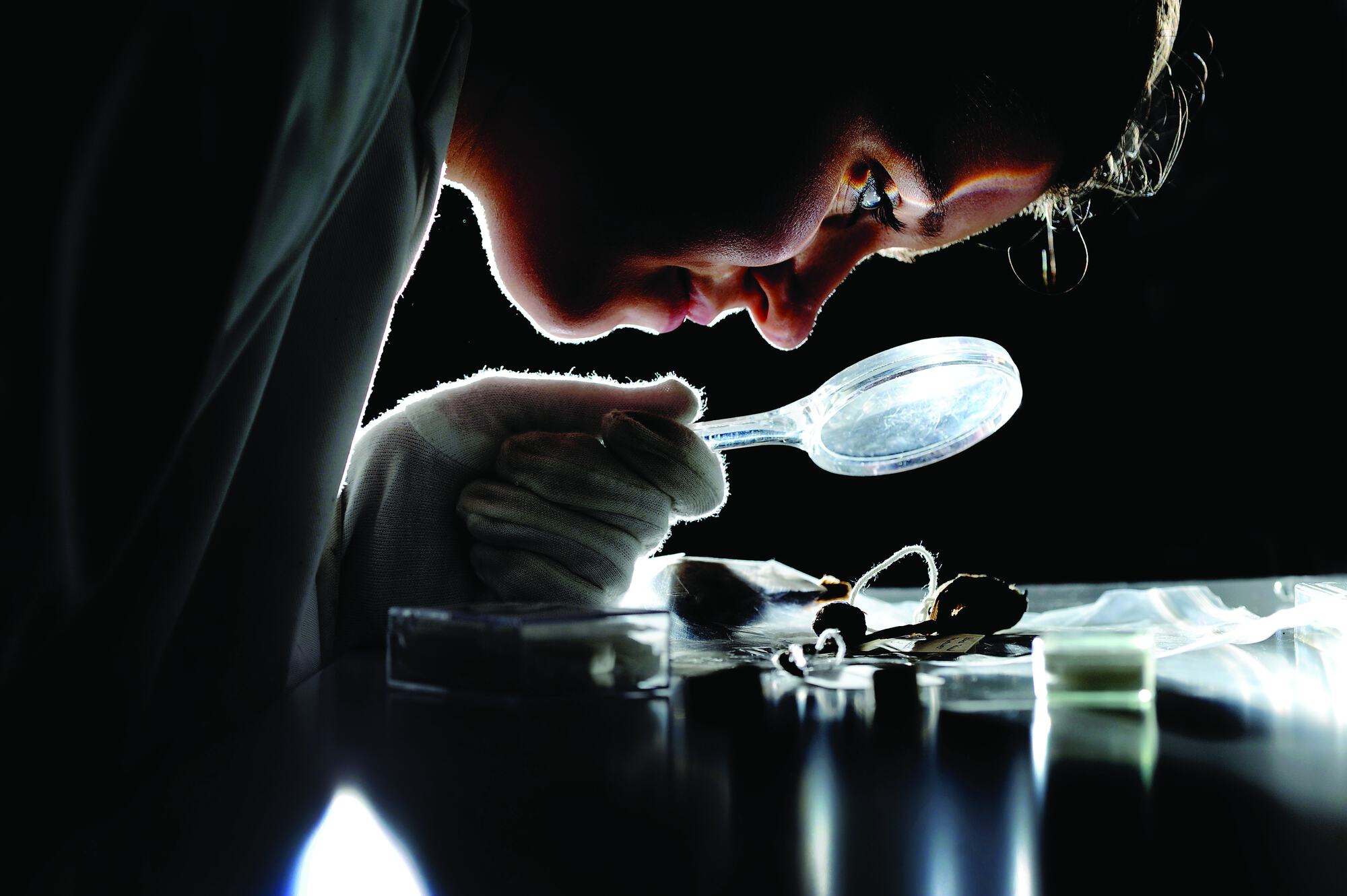 Student Laura Bradbeer, 20, uses magnifying glass on an Archaeology Placement from Bradford University at The Leeds Museum Discovery Centre.